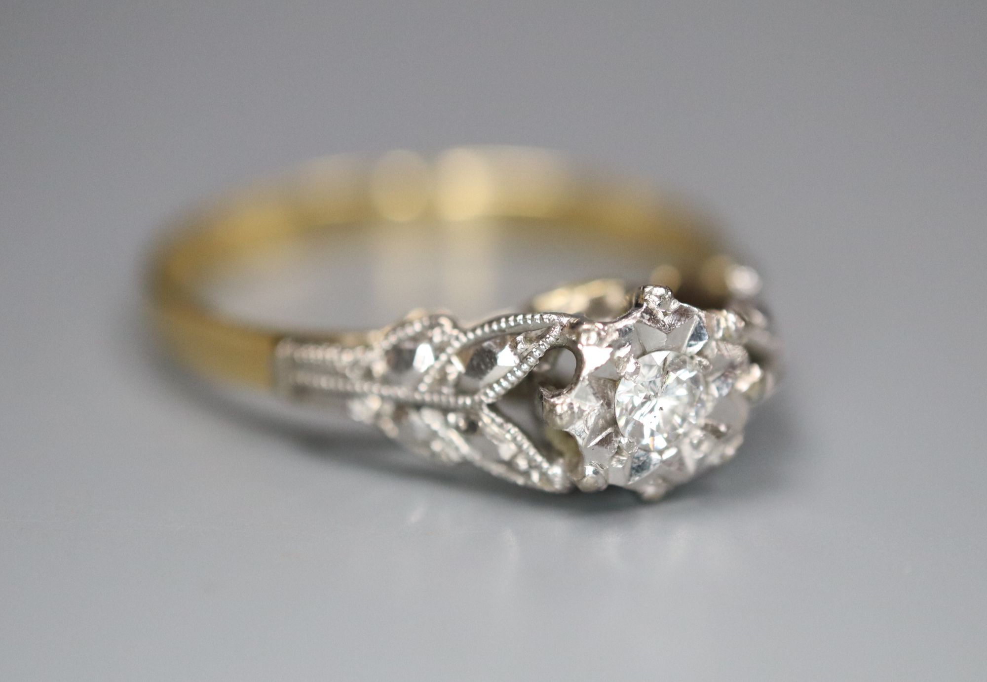 A 1960s 18ct gold and plat, illusion set solitaire diamond ring, size L, gross 2.3 grams.